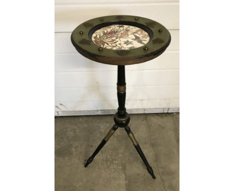A black and gilt ceramic topped plant stand with tripod legs.  Approx 76cm tall