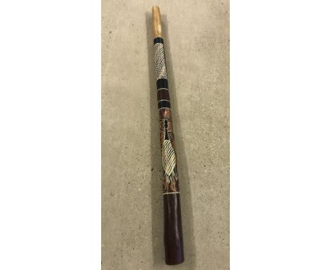 A large wooden didgeridoo with hand painted decoration.  Approx. 131cm long.