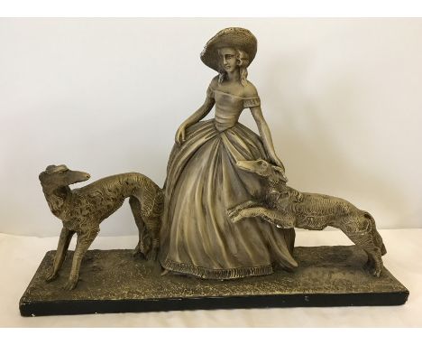 A vintage plaster figurine of a classical lady with two Irish Wolfhounds.  Approx 60.5cm x 42cm tall.