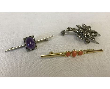 3 vintage silver brooches. One with a flower design set with marcasite, one a bar brooch with amethyst cabochon and one silve