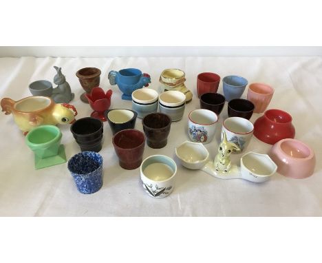 A small quantity of vintage egg cups. To include early plastic, Ridgeway potteries Hannah Barbera characters and Goebel. 