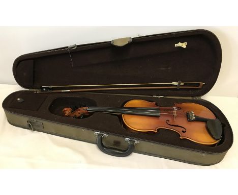 A cased violin with bow and rosin. A copy of Antonius Stradivarius. Violin approx. 56cm long.