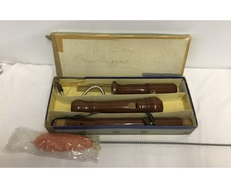 A vintage Günter Wunderlich bass recorder in original box together with a new cleaning mop.  