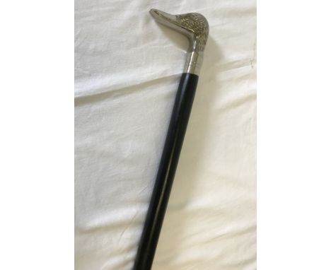 A black wooden walking stick with silver coloured ducks head handle.  Approx. 93cm long.