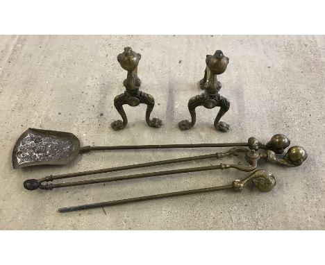 A pair of vintage brass firedogs with ball and claw design. Together with a set of matching fire Irons. 