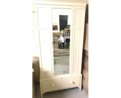 A vintage mirror doored single wardrobe, painted cream. with drawer to lower section a removable pelmet. 
