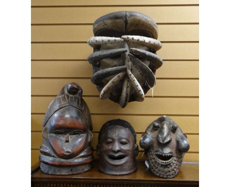 FOUR AFRICAN 'HELMET' MASKS including Wum mask, Mende bundu society mask, Makonde mask and Bete spider mask (4)