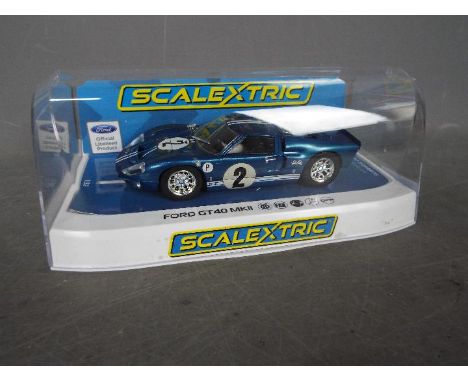 Scalextric - A 1967 Ford GT40 MkII from the Sebring 12 hours race. The car appears Mint in a Very Good display case with ligh