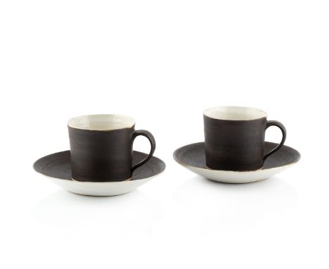 Lucie Rie (1902-1995)Two cups and saucersmanganese glazepotter's seal mark to each piececup measures 6cm high, saucer measure
