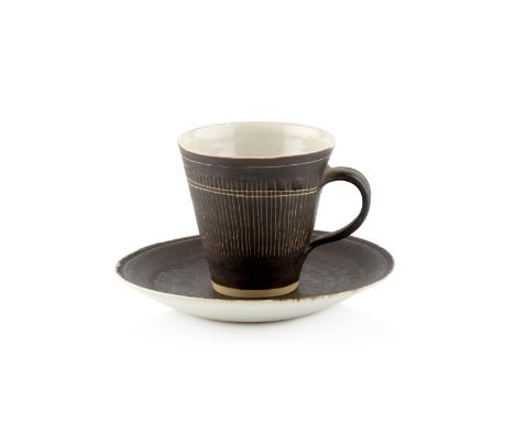 Lucie Rie (1902-1995)Cup and saucermanganese glaze, sgraffito decorationimpressed potter's sealcup 7.5cm high, 14cm diameter 