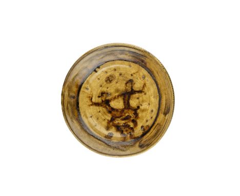 Bernard Leach (1887-1979) Early dish, 1927slipware with galena glaze, depicting two figures on a rock, sat underneath star co