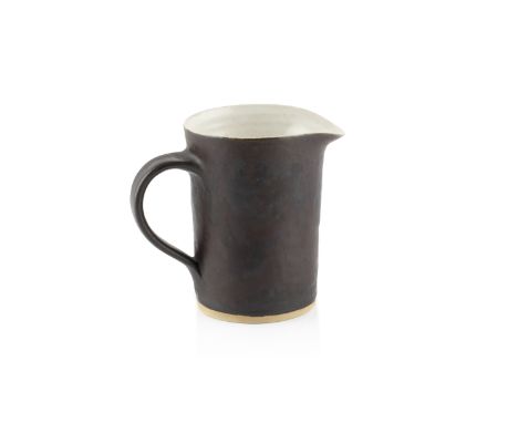 Lucie Rie (1902-1995)Milk jugmanganese glazeimpressed potter's seal9.5cm high.  Condition appears good with no damage or rest