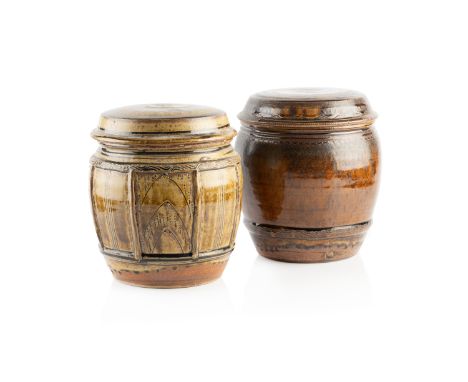 Mike Dodd (b.1943) Two large jars and coversone with light brown glaze, with panels having incised decoration, the other dark