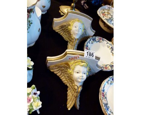 Pair of cast plaster cherub shelf supports 