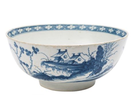 A First Period Worcester blue and white bowl: painted in 'The Precipice' pattern of buildings and a bridge in a lake landscap