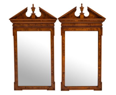 A pair of contemporary yew-wood veneered architectural mirrors:, with moulded broken pediments, each centred by an urn and wi