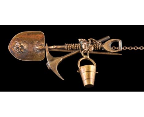 A gold miner's bar brooch: in the form of a shovel and axe, approximately 4.5g gross weight. 