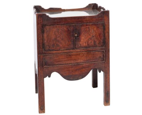 A George III mahogany converted tray top commode:, the ledge gallery with carrying handles, enclosed by a pair of doors and w