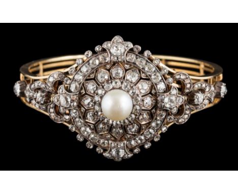 A late 19th century diamond and pearl circular cluster brooch/bangle: the central pearl measuring approximately 9mm diameter 