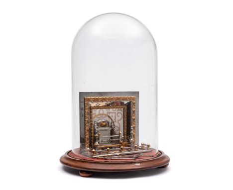 A steel and gilt metal miniature model of a fireplace: of rectangular outline, with tiled back, steel basket with gilded bead