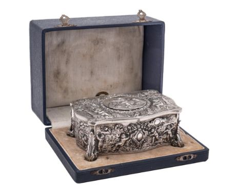 A Swiss silver plated automaton musical box: of serpentine outline decorated with putti in forest glades, the oval hinged top