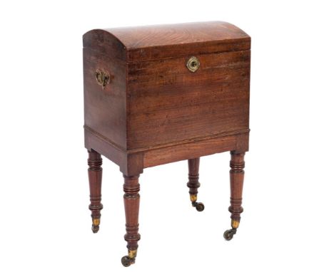 An early 19th Century mahogany domed top trunk shaped cellarette:, the hinged top enclosing an interior with six divisions, h