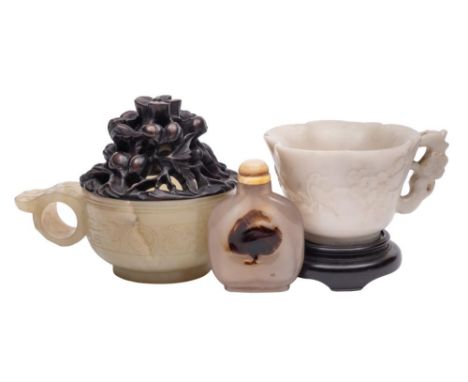 A Chinese jade archaistic cup, a white hardstone cup and an agate snuff bottle and cover: the first with single pointed loop 