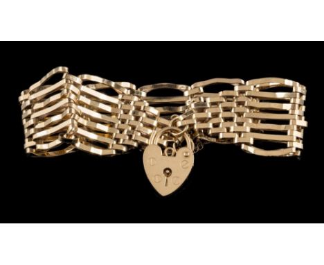 A 9ct gold seven bar, gate-link bracelet: with attached heart-shaped padlock clasp and safety chain, approximately 11.5gms gr