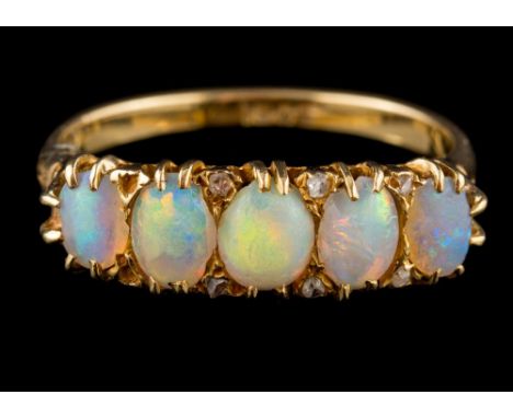 An 18 carat gold and opal five-stone ring: set with graduated oval opals between rose-diamond points, ring size P. 