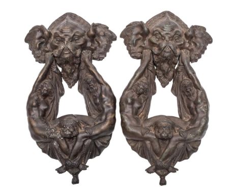 A pair of cast bronze patinated door knockers: with grotesque mask mount, the figural knocker of a neo-classical man and wome