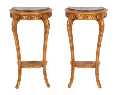 A pair of French carved giltwood demi lune console tables:, each with a green variegated marble top, having a pierced flowerh