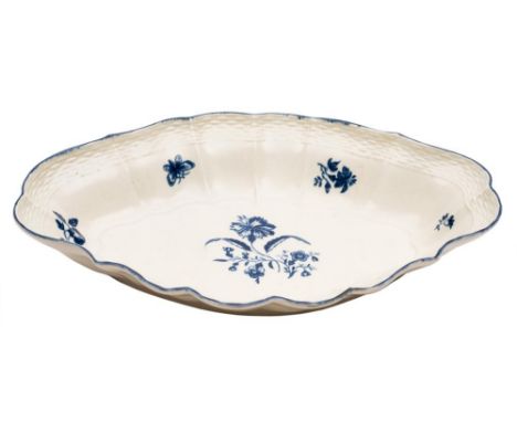 A First Period Worcester blue and white oval dish: the scallop shaped rim with basket weave border, decorated in 'The Gillifl