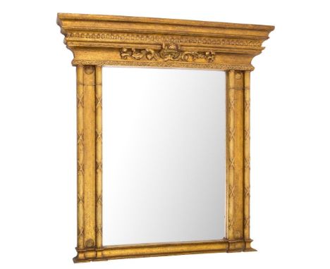 A contemporary gilt wood architectural overmantel mirror:, with a moulded cornice and foliate scroll frieze, centred by a she