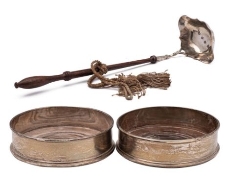 A pair of Elizabeth II silver wine coasters, maker CSR Ltd, London, 1977: of plain circular form with turned wood base, 12.5c