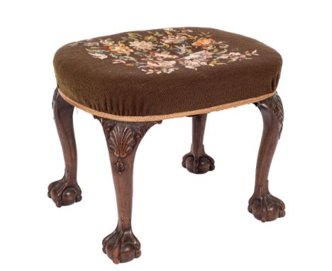 A carved walnut oval stool in the George II manner:, with a stuff over seat, upholstered in gros point floral foliate needlew