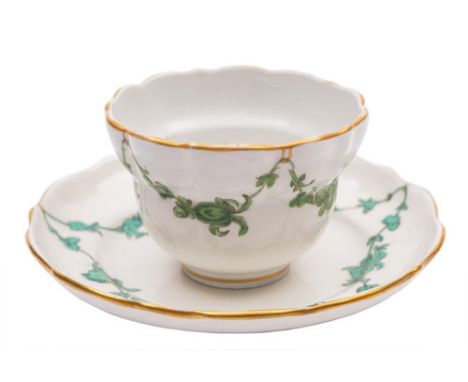 A Bristol tea bowl and saucer: of fluted ogee form, painted in green monochrome with floral swags, X10 mark, circa 1775-80, d