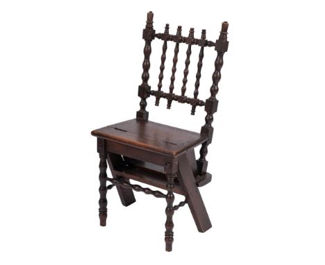 A 19th Century oak metamorphic library step chair:, with bobbin turned back and hinged seat converting to a three tread steps