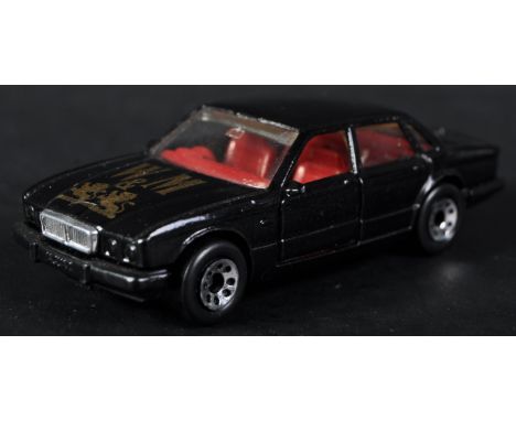 A vintage 1980's (1986) Matchbox Jaguar XJ6 ' Whyte &amp; Mackay ' promotional diecast model. Black bodywork with gold ' W&am