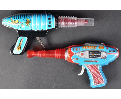 Two vintage circa 1950s / 1960s tinplate and plastic friction sparking Rocket Pistol Ray Guns. One being a Hungarian made exa