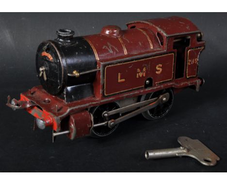 A vintage Hornby O gauge tinplate clockwork model railway trainset locomotive 2115 LMS maroon livery. Smooth running mechanis