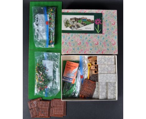 An original vintage Britain's Garden set No. R691. The set containing a large quantity of plastic flowers and foliage, lawn a