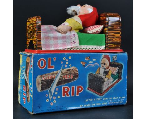 A vintage Japanese ' Spesco ' made tinplate battery operated mechanical toy ' Ol Sleepy Head Rip '. Tinplate lithographed bed