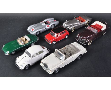 A collection of x7 assorted Franklin Mint 1/24 scale precision diecast model cars to include; 1961 Jaguar E Type, 1967 Morris