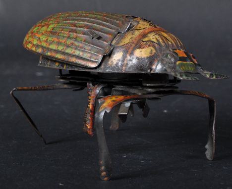 A vintage believed German made tinplate mechanical / clockwork crawling Beetle. Litho printed tinplate body and wings that fl