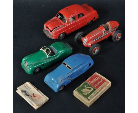 A collection of vintage Triang / Minic and Schuco tinplate clockwork model cars. Two with red and blue exteriors, one green p