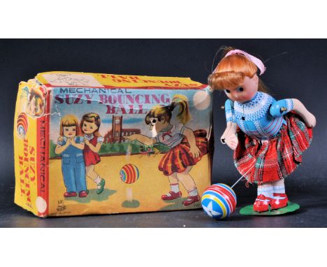 A vintage Japanese tinplate clockwork mechanical toy ' Suzy Bouncing Ball '. Tinplate lithographed constructed body with plas
