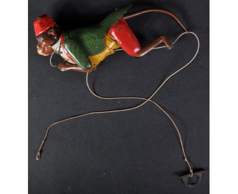 An original vintage German Lehmann made tinplate mechanical climbing monkey. The monkey suspended on a string that when held 