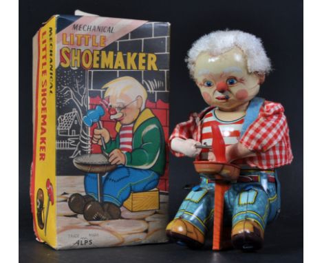 A vintage Japanese ' Alps ' made mechanical tinplate clockwork ' Little Shoemaker '. Lithographed tinplate with fabric hair. 
