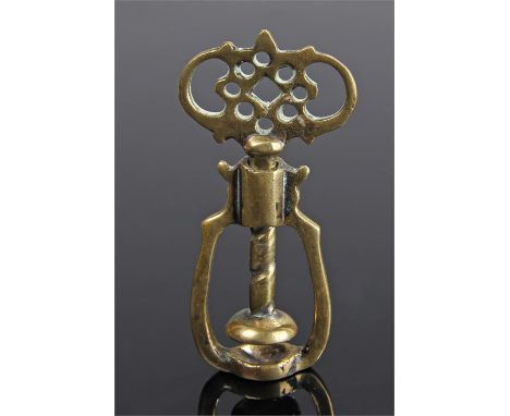 Rare George III brass nut crackers, with pierced top with twist lugs, above a threaded shaft and cracker, 7.5cm high