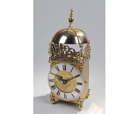 17th Century brass lantern clock, anonymous, the finial top above a bell and foliate pierced frieze, urn shaped finials above